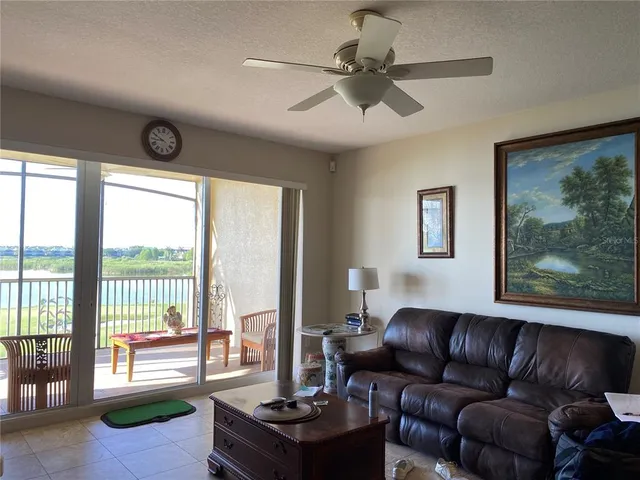 a living room with furniture and a floor to ceiling window