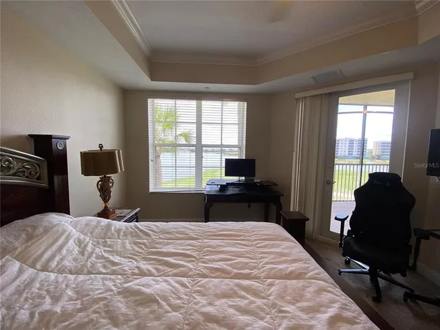 a bedroom with a bed and a chandelier