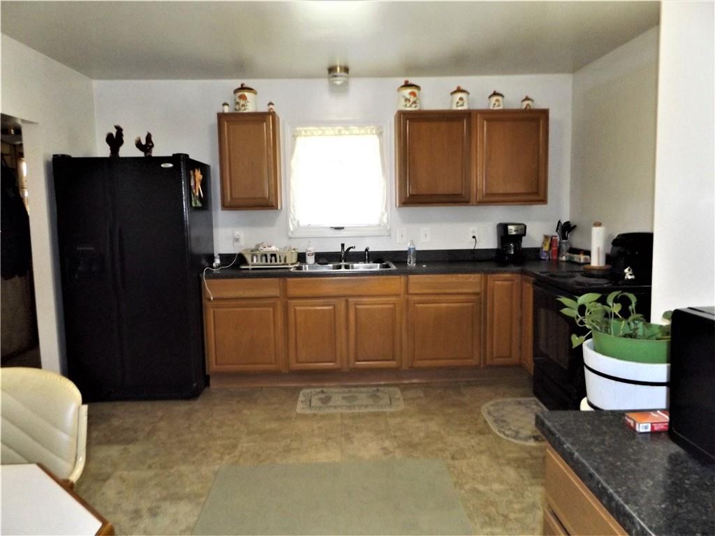 438 Cottage Road Smock, PA 15480 - Photo 5 of 17 a kitchen with stainless steel appliances granite countertop a sink stove and refrigerator