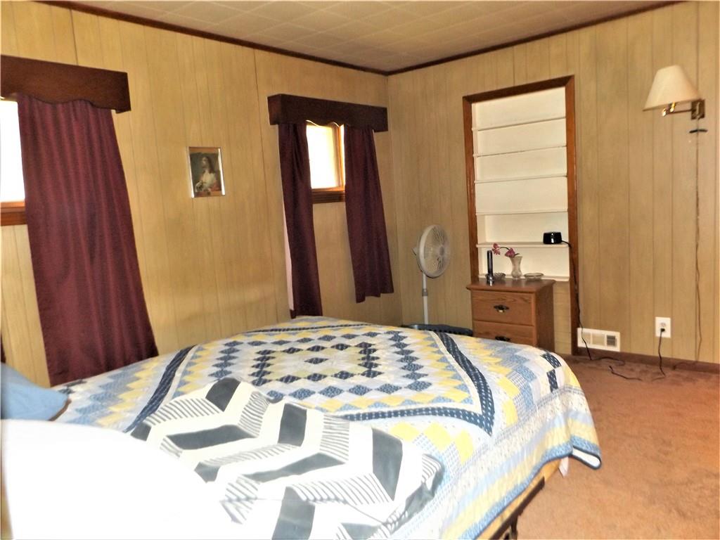 438 Cottage Road Smock, PA 15480 - Photo 8 of 17 a bedroom with a bed and a mirror