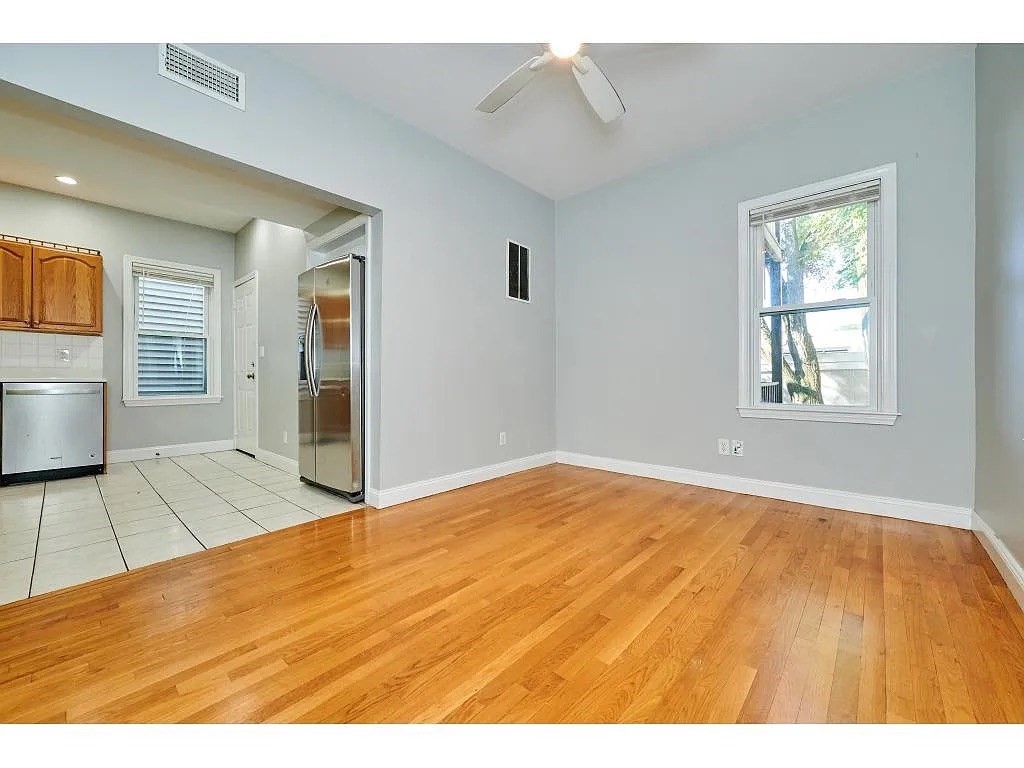 5-7 Transit Street, Unit 5 2 Boston, MA 02127 - Photo 2 of 7 a view of an empty room with wooden floor and a window