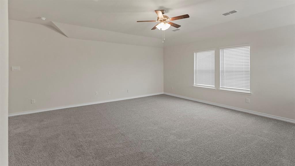 447 Epiphany Lane Lavon, TX 75166 - Photo 28 of 31 Spacious room featuring neutral carpeting, light-toned walls, and a ceiling fan with integrated lighting