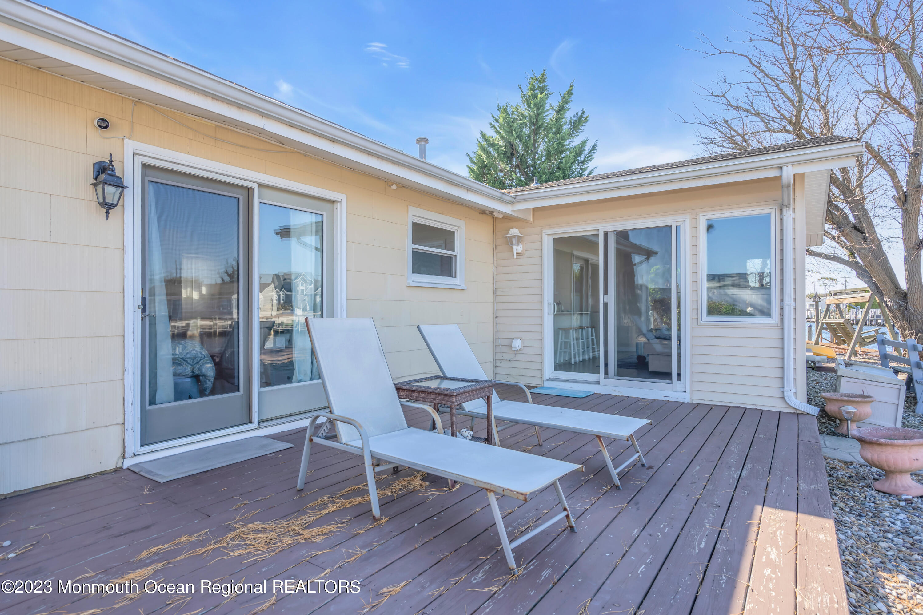 119 Caldwell Road Barnegat, NJ 08005 - Photo 29 of 51 a view of a patio with table and chairs with wooden floor and fence