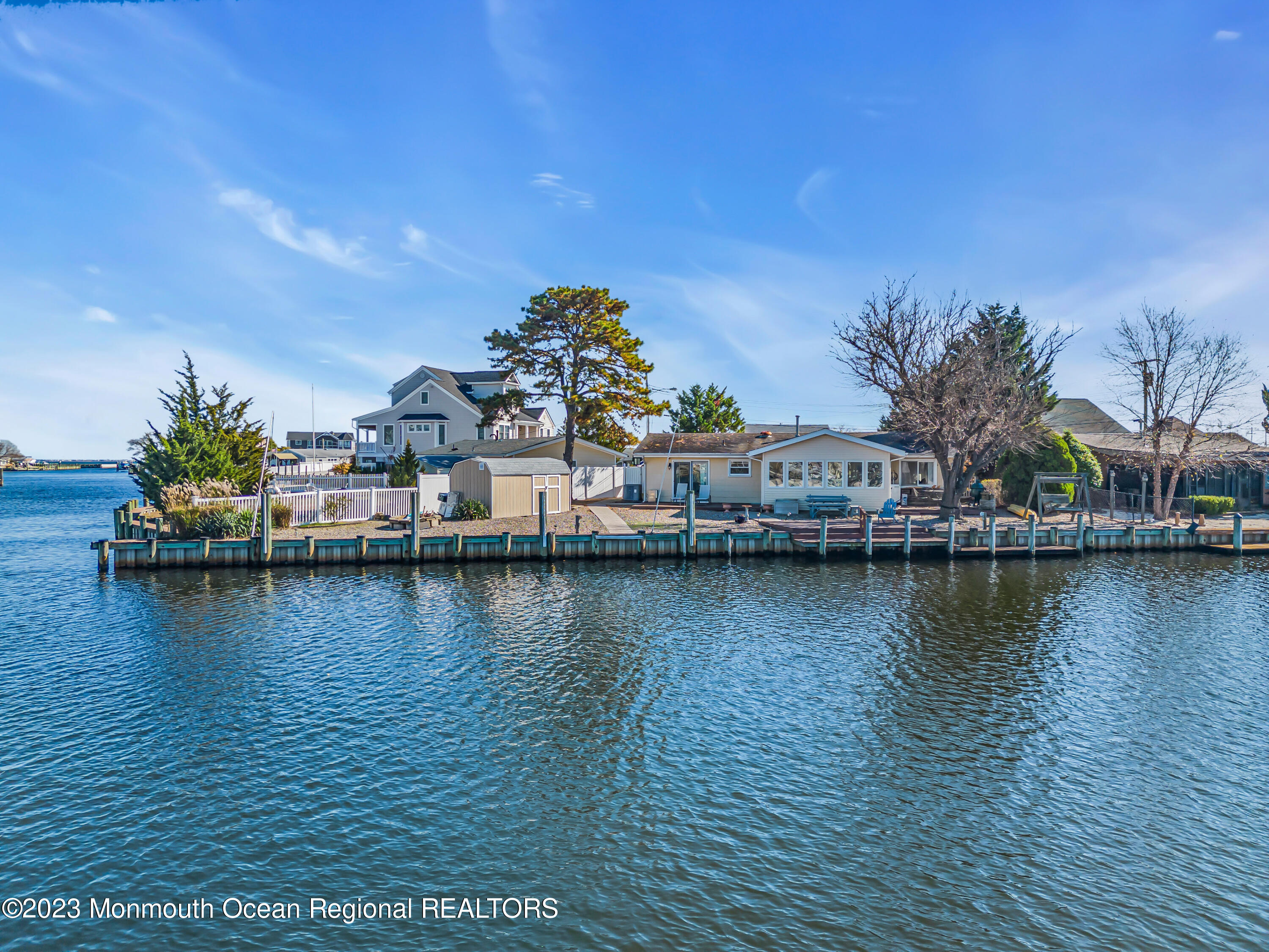 119 Caldwell Road Barnegat, NJ 08005 - Photo 45 of 51 a view of a ocean with boats and trees in the background