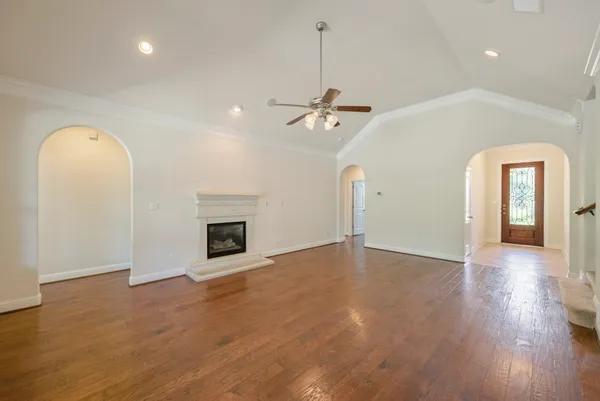 wooden floor in an empty room with a fireplace