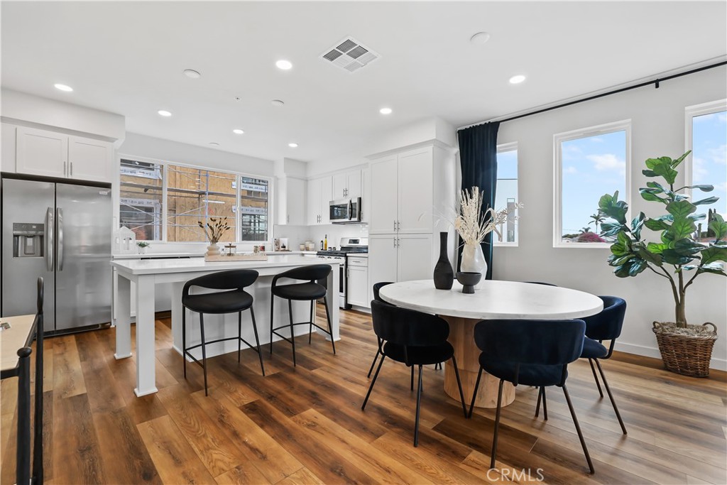 a view of a dining room with furniture window and wooden floor