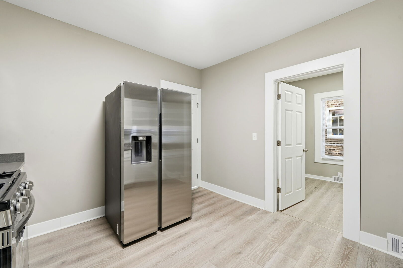 1217 North Harding Avenue Chicago, IL 60651 - Photo 12 of 45 an empty room with wooden floor and a hallway