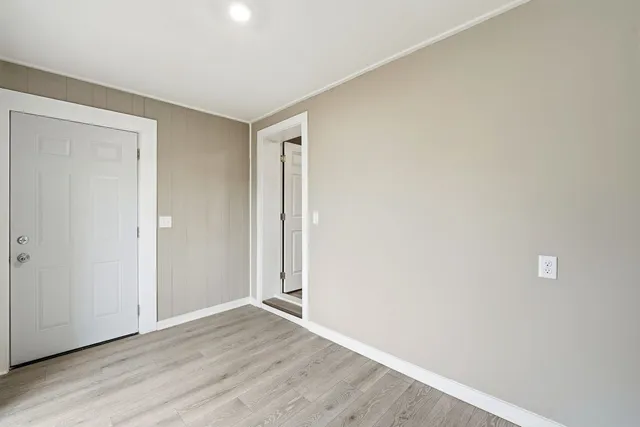 a view of an empty room with wooden floor