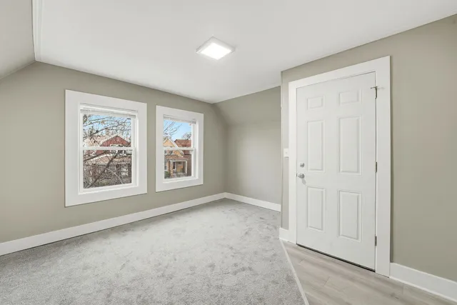 an empty room with windows and closet