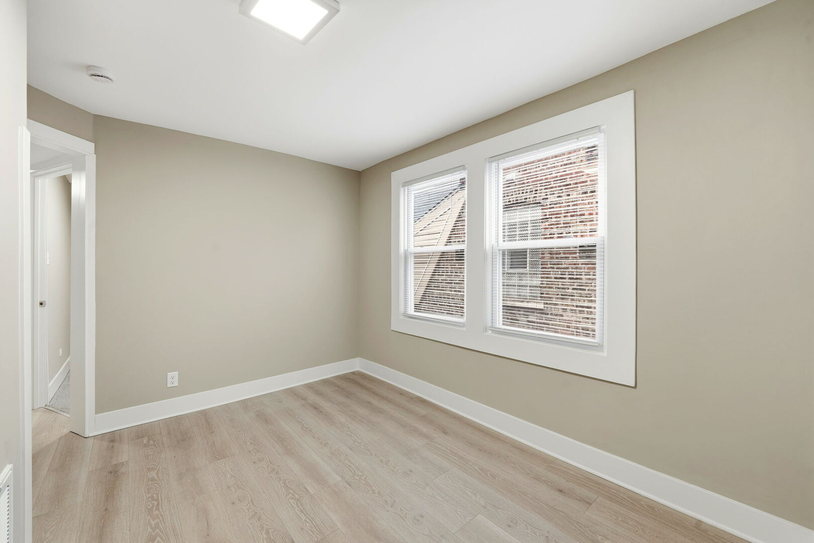 1217 North Harding Avenue Chicago, IL 60651 - Photo 18 of 45 a view of an empty room with wooden floor and a window