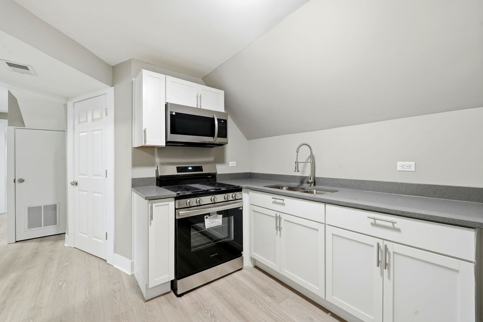 1217 North Harding Avenue Chicago, IL 60651 - Photo 24 of 45 a kitchen with stainless steel appliances granite countertop a stove a sink and a microwave