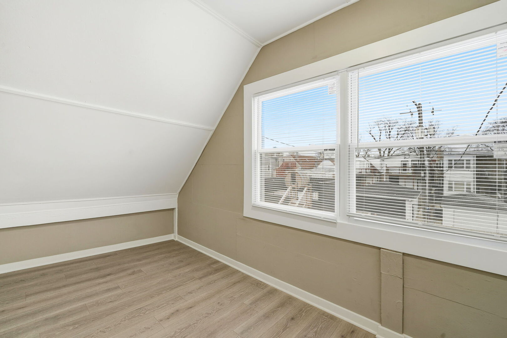 1217 North Harding Avenue Chicago, IL 60651 - Photo 27 of 45 a view of an empty room with wooden floor and a window