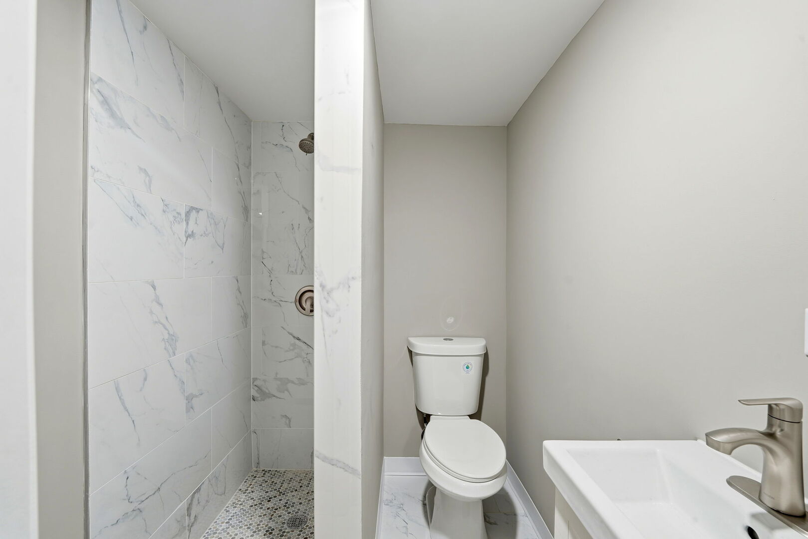 1217 North Harding Avenue Chicago, IL 60651 - Photo 35 of 45 a white toilet sitting next to a bathroom sink