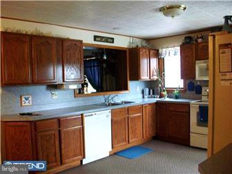140 Harris Road Mannington, NJ 08079 - Photo 4 of 12 a kitchen with stainless steel appliances granite countertop wooden cabinets a sink and a stove