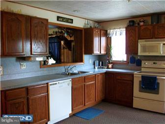 140 Harris Road Mannington, NJ 08079 - Photo 5 of 12 a kitchen with stainless steel appliances a stove a sink and a microwave