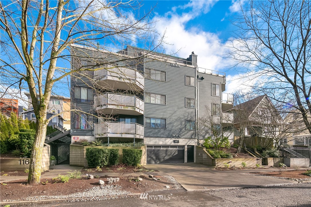 116 11th Avenue East, Unit 402 Seattle, WA 98102 - Photo 1 of 22 a view of a building with a yard