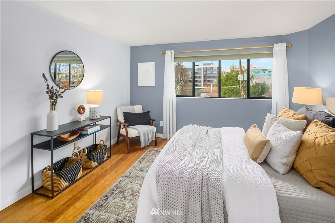 116 11th Avenue East, Unit 402 Seattle, WA 98102 - Photo 11 of 22 a bedroom with bed and a large window
