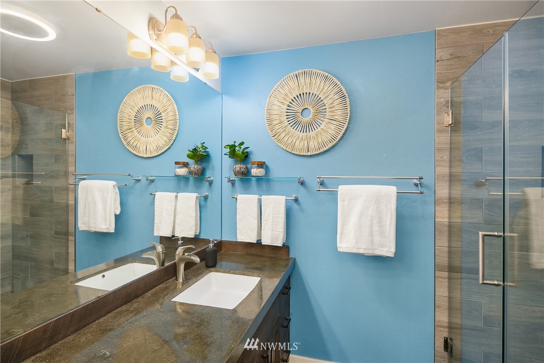 116 11th Avenue East, Unit 402 Seattle, WA 98102 - Photo 13 of 22 a bathroom with a sink and a mirror