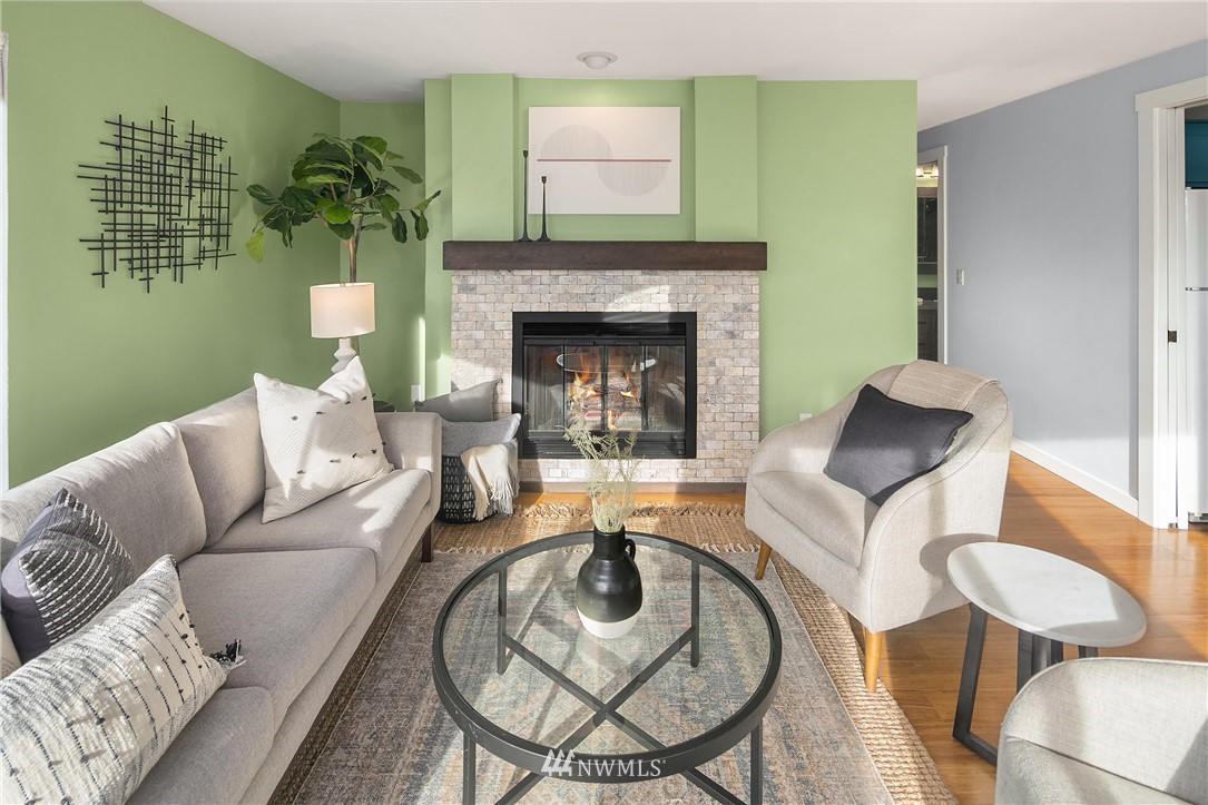 116 11th Avenue East, Unit 402 Seattle, WA 98102 - Photo 5 of 22 a living room with furniture and a fireplace