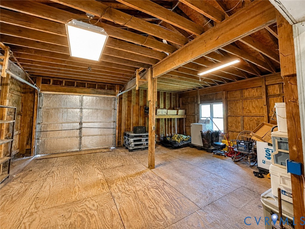 218 Deer Run Road Blackstone, VA 23824 - Photo 66 of 90 Spacious garage with exposed wood beams, plywood f