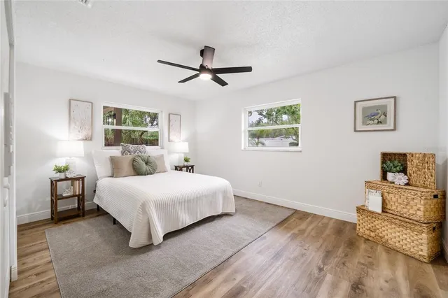 a spacious bedroom with a bed and painting on the wall