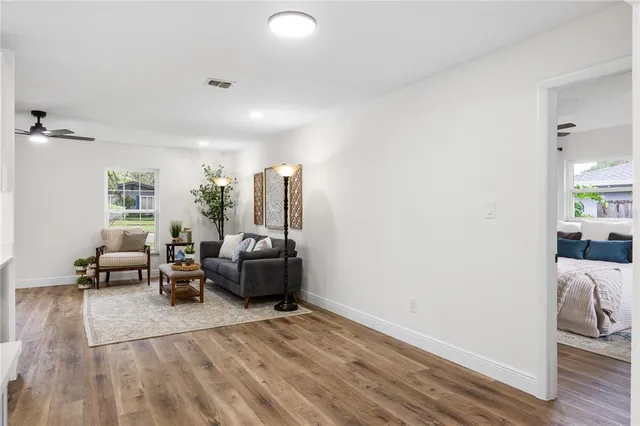 a living room with furniture and a wooden floor