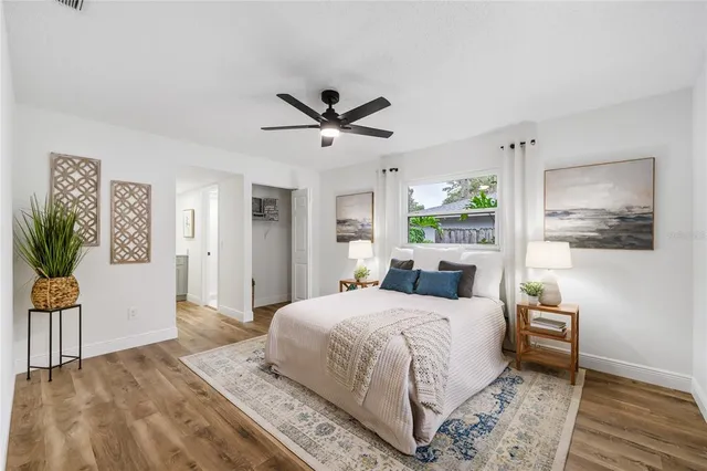 a bedroom with a large bed and a chandelier
