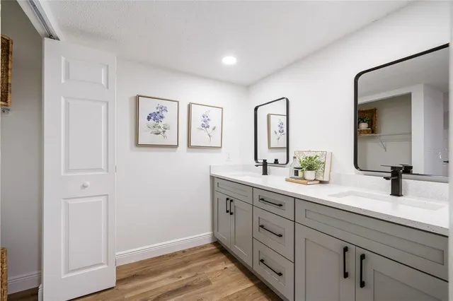 a bathroom with a double vanity sink and a mirror