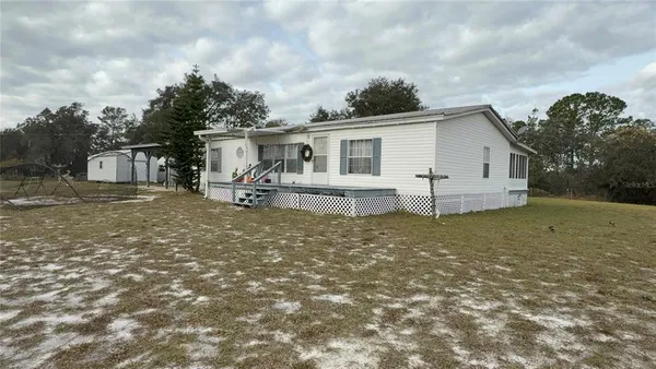 a view of a yard with a tree