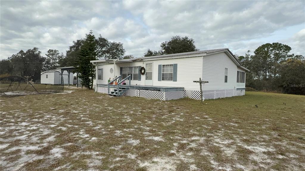 29605 Fullerville Road DeLand, FL 32720 - Photo 2 of 37 a view of a house with backyard and garden