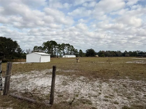 a view of a house with a yard and garage