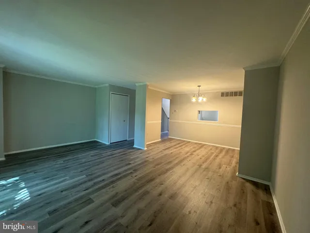 wooden floor in an empty room with wooden floor and a window
