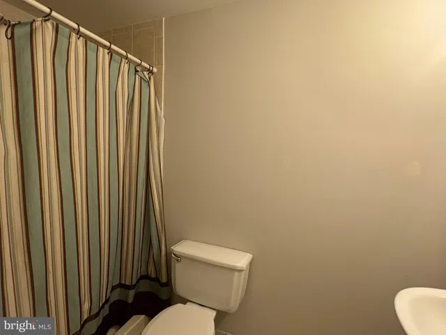 a white toilet sitting next to a small bathroom