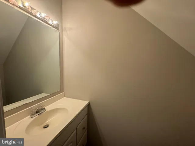 a bathroom with a sink and vanity