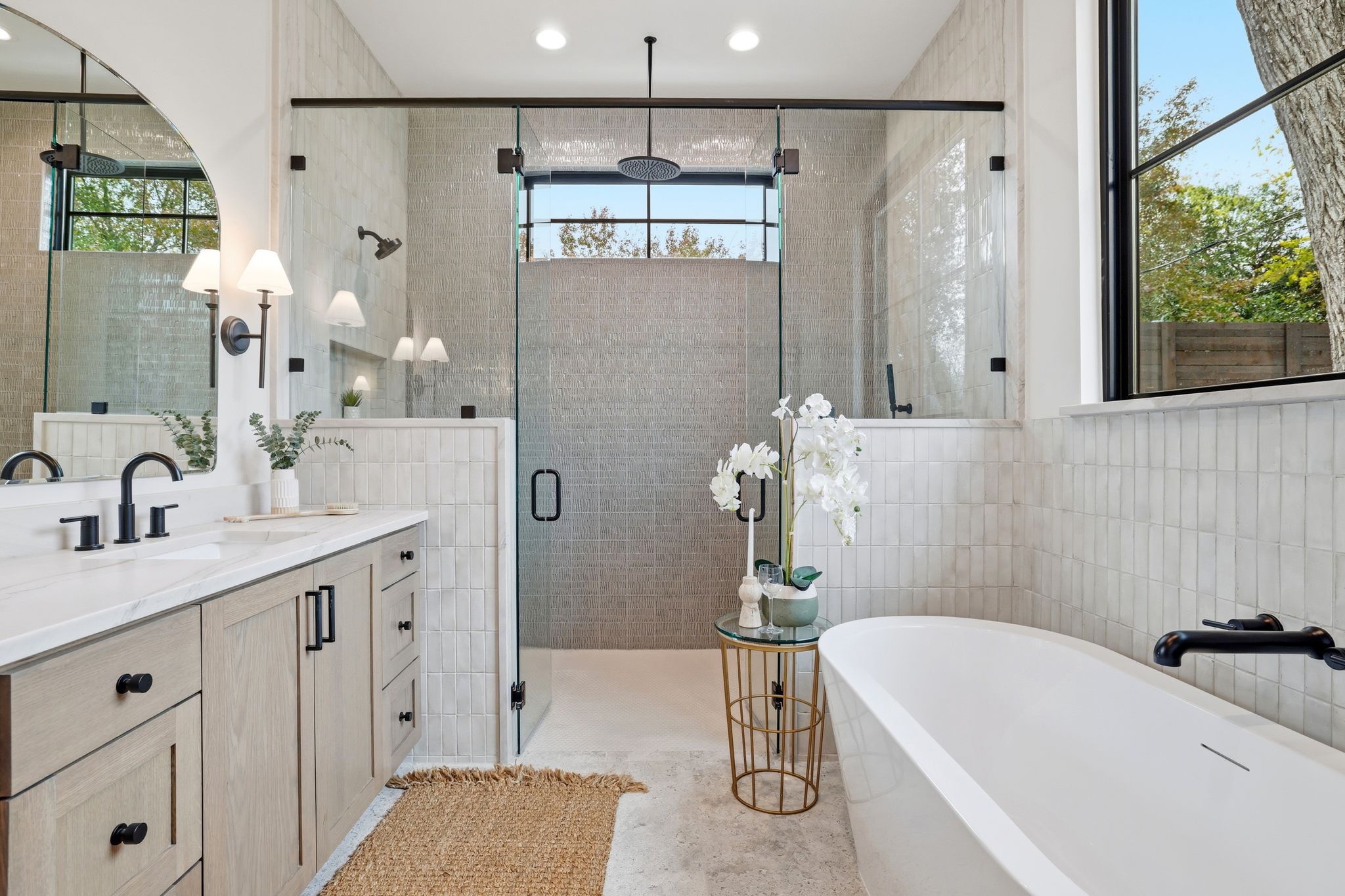 2908 Stoneway Drive Austin, TX 78757 - Photo 20 of 35 a bathroom with a tub sink and mirror