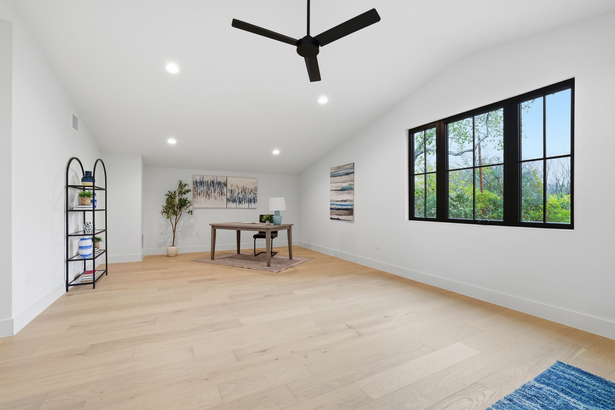 2908 Stoneway Drive Austin, TX 78757 - Photo 22 of 35 a view of a livingroom with a large window and a ceiling fan