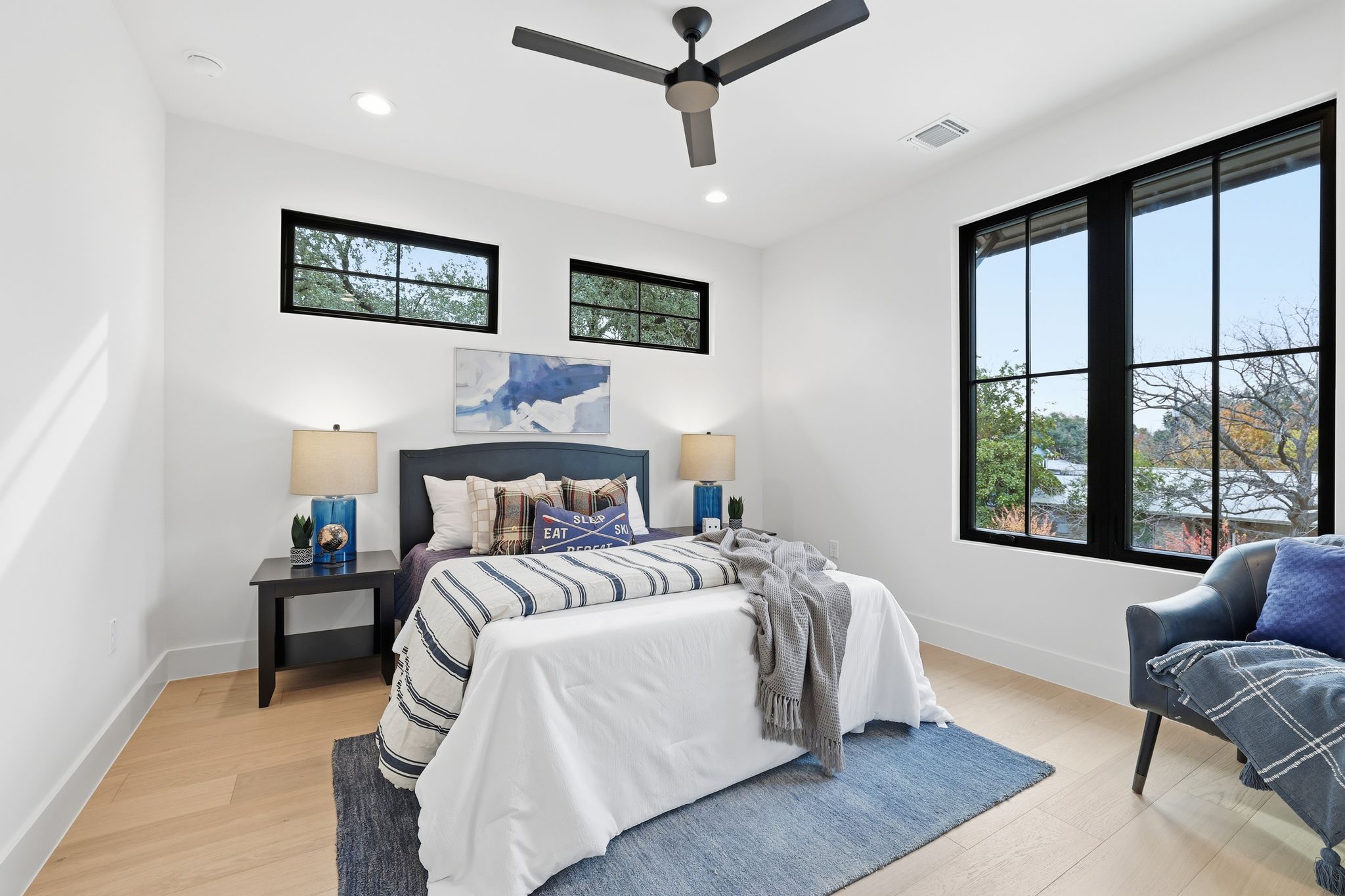 2908 Stoneway Drive Austin, TX 78757 - Photo 25 of 35 a bedroom with a bed couch and a window