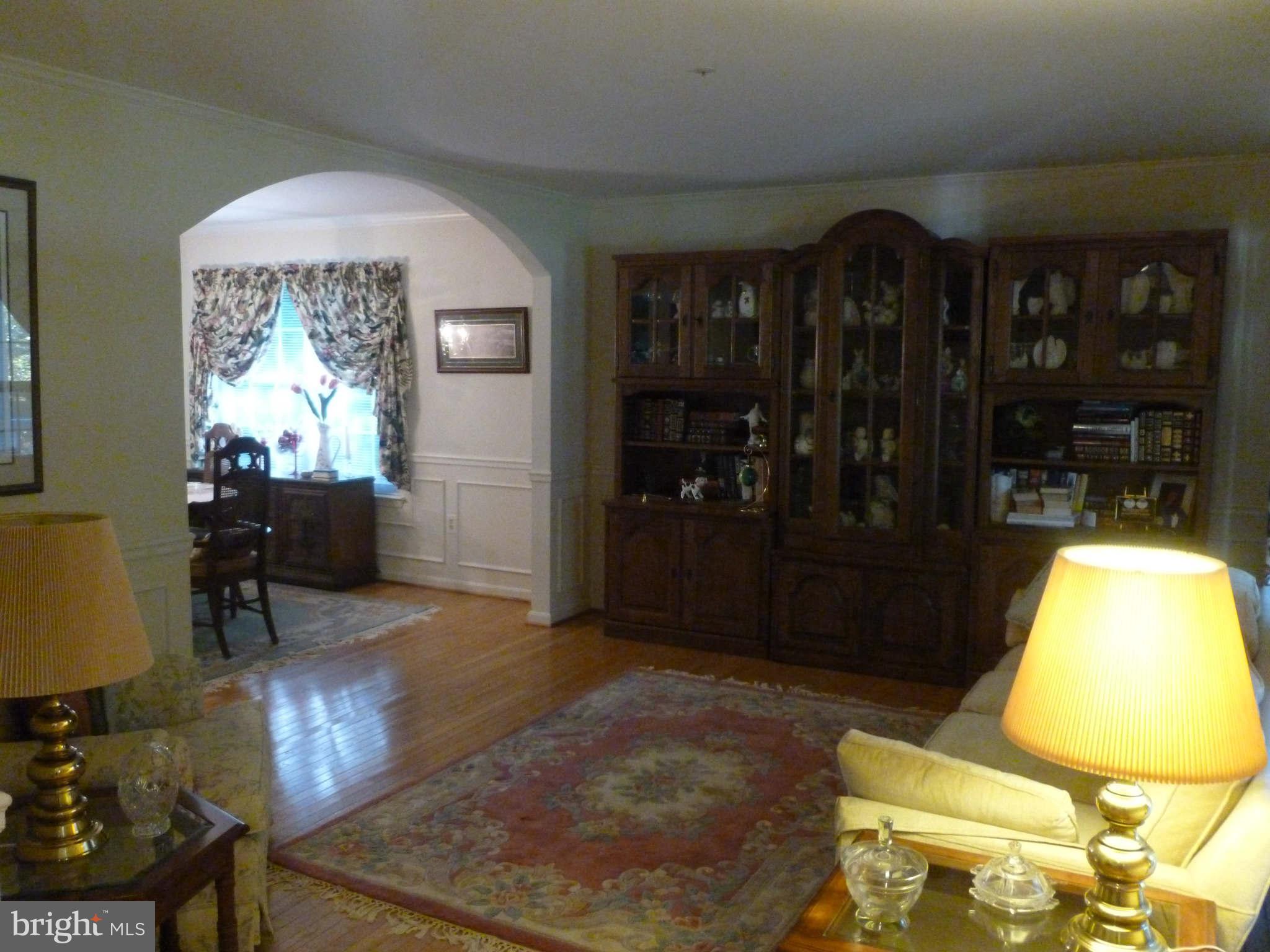 670 Small Reward Road Huntingtown, MD 20639 - Photo 6 of 26 a living room with furniture and a chandelier
