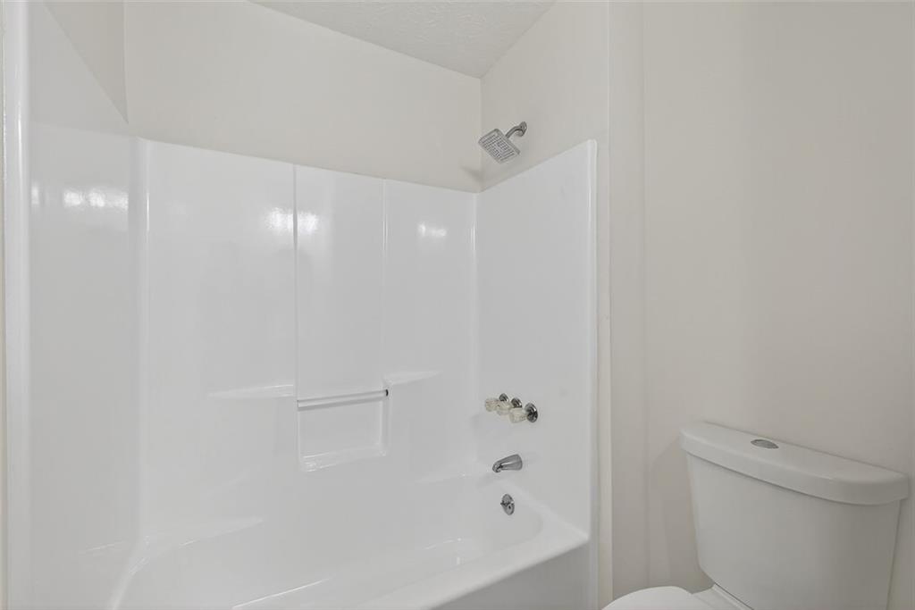37 Peach Forest Way Douglasville, GA 30134 - Photo 11 of 30 a bathroom with a bathtub and a toilet