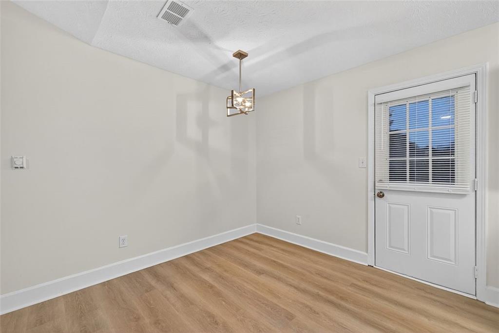 37 Peach Forest Way Douglasville, GA 30134 - Photo 12 of 30 an empty room with wooden floor and windows