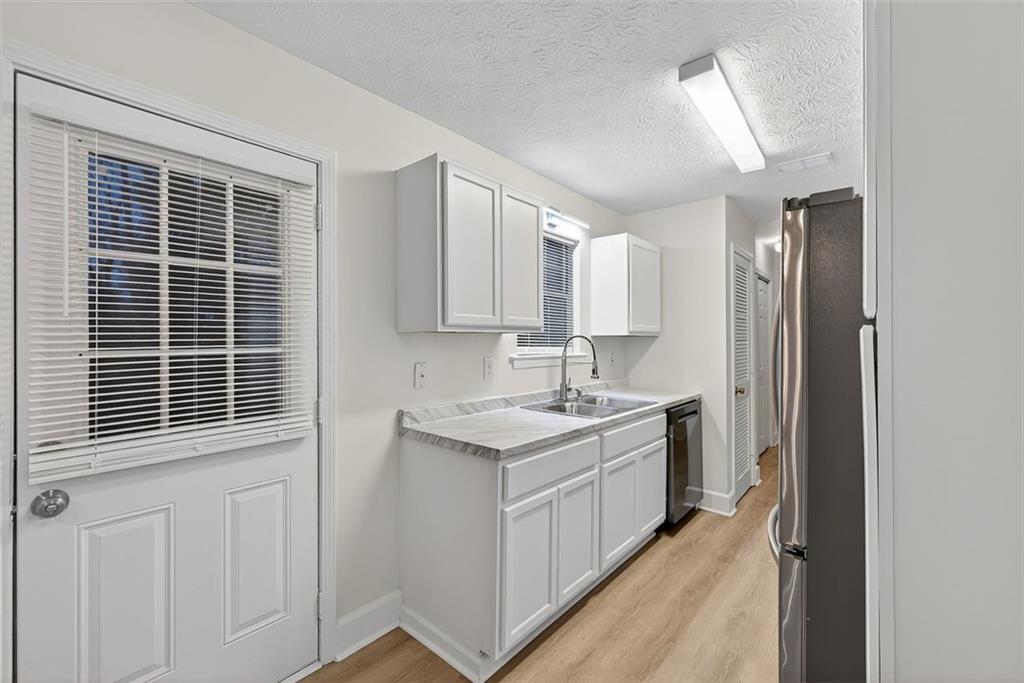37 Peach Forest Way Douglasville, GA 30134 - Photo 13 of 30 a kitchen with a sink stove and cabinets