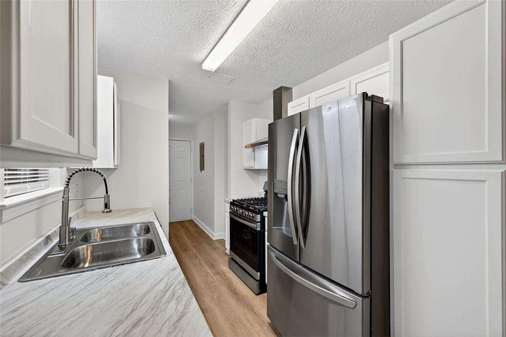 37 Peach Forest Way Douglasville, GA 30134 - Photo 14 of 30 a kitchen with stainless steel appliances granite countertop a refrigerator and a sink