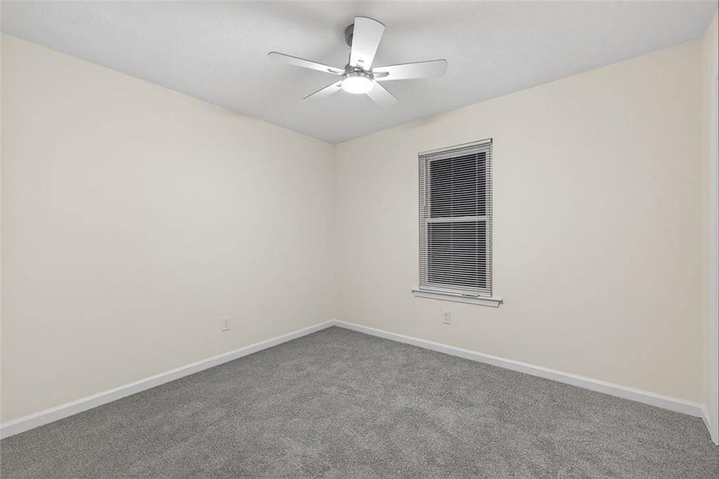 37 Peach Forest Way Douglasville, GA 30134 - Photo 17 of 30 an empty room with a window and a ceiling fan