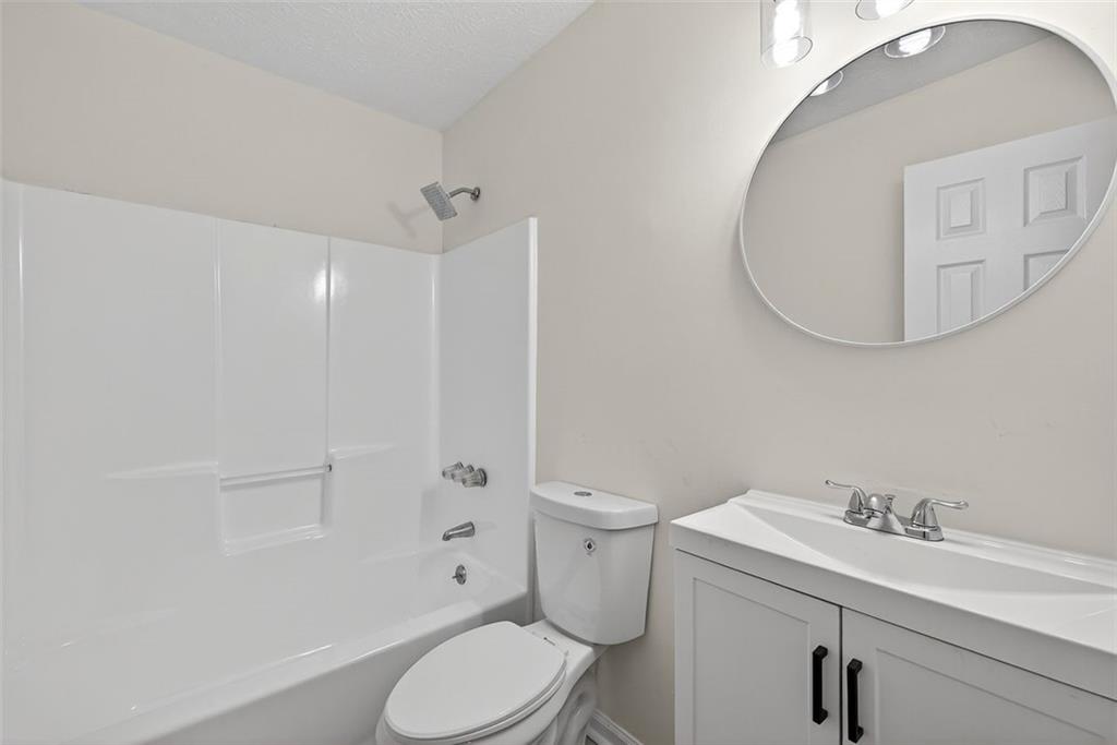 37 Peach Forest Way Douglasville, GA 30134 - Photo 19 of 30 a bathroom with a sink a toilet and shower