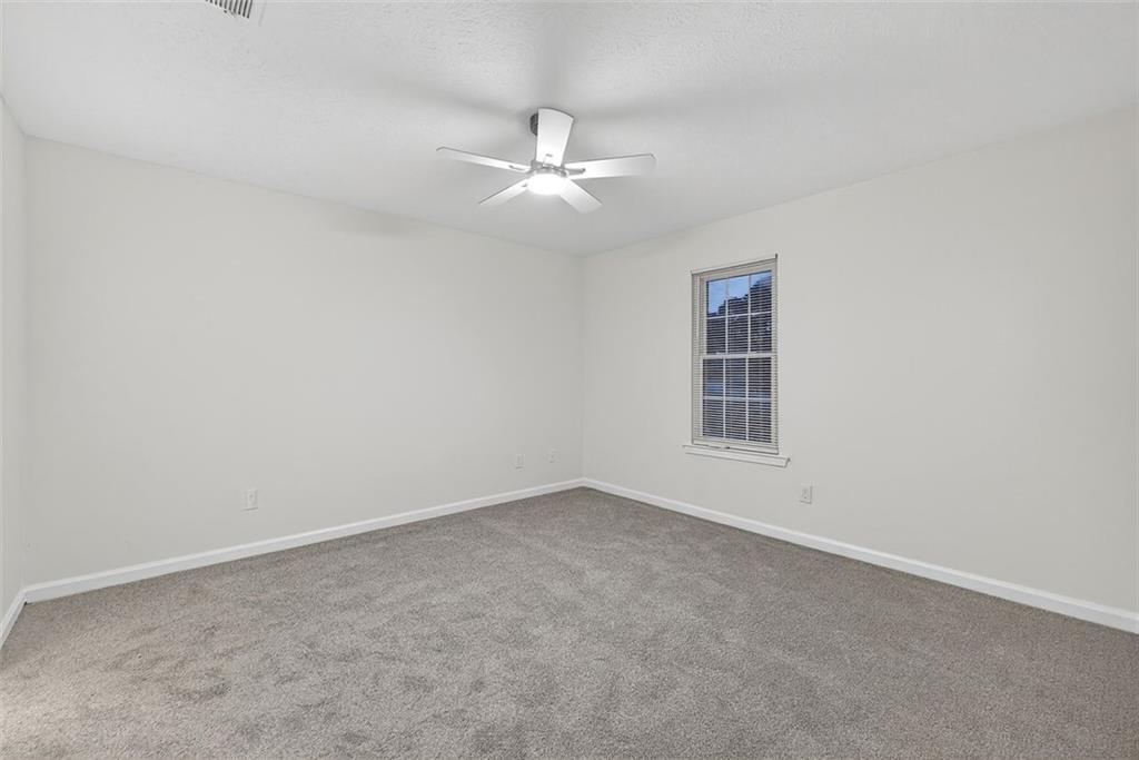 37 Peach Forest Way Douglasville, GA 30134 - Photo 8 of 30 an empty room with ceiling fan and window