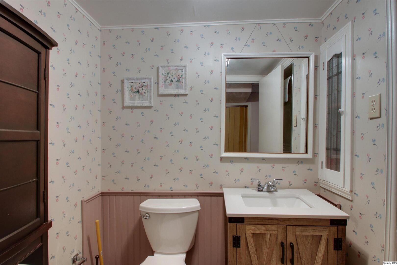 3608 Columbus Road Quincy, IL 62305 - Photo 12 of 17 a bathroom with a toilet sink and mirror