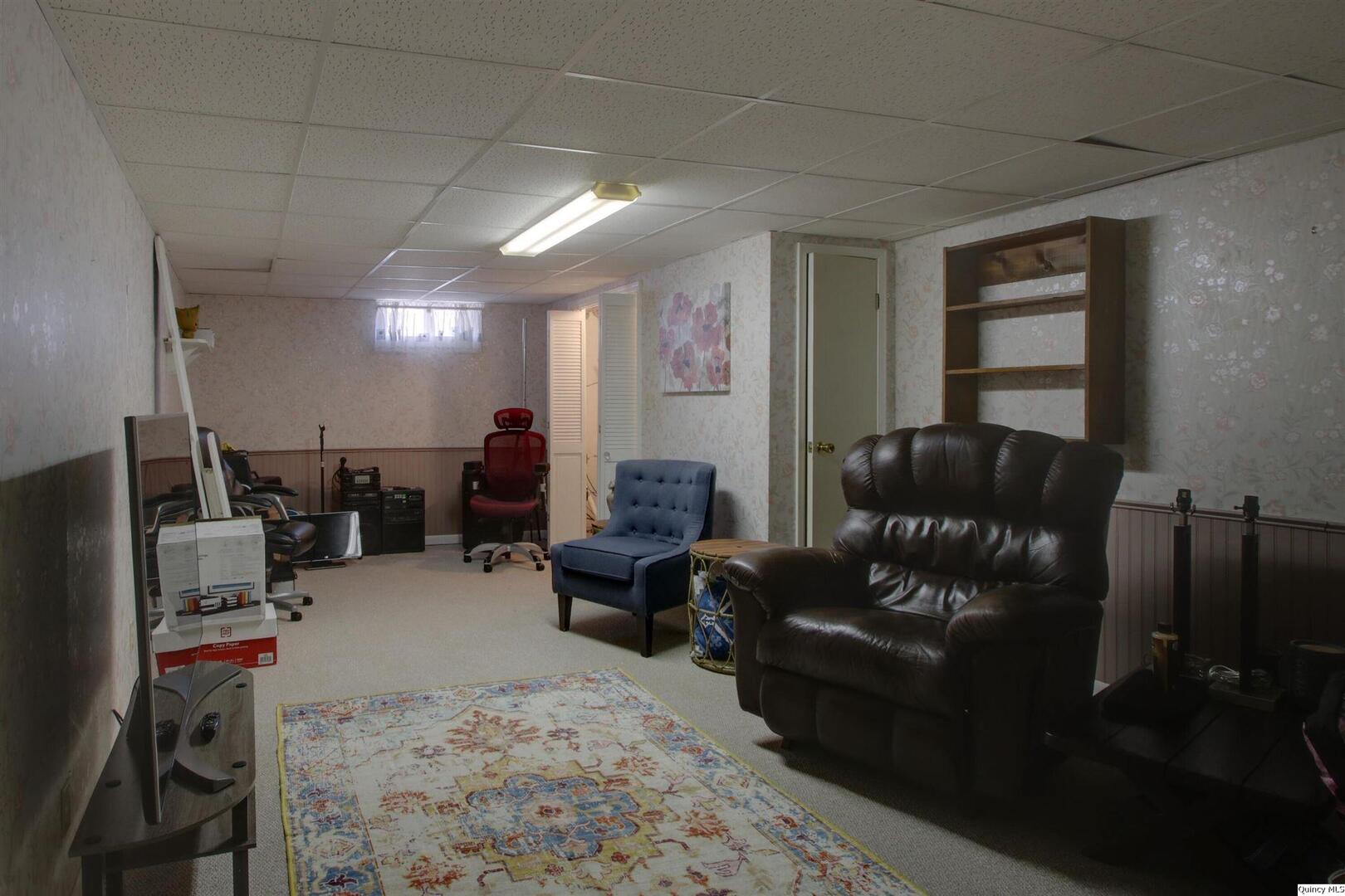 3608 Columbus Road Quincy, IL 62305 - Photo 13 of 17 a living room with furniture a flat screen tv and a window