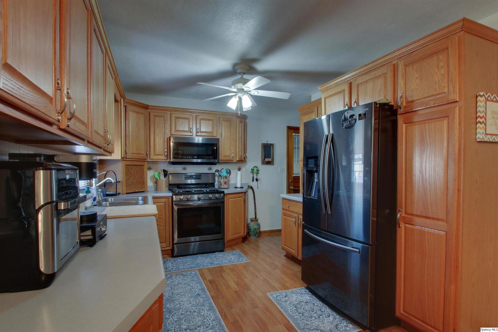 3608 Columbus Road Quincy, IL 62305 - Photo 6 of 17 a kitchen with stainless steel appliances granite countertop a refrigerator stove and microwave