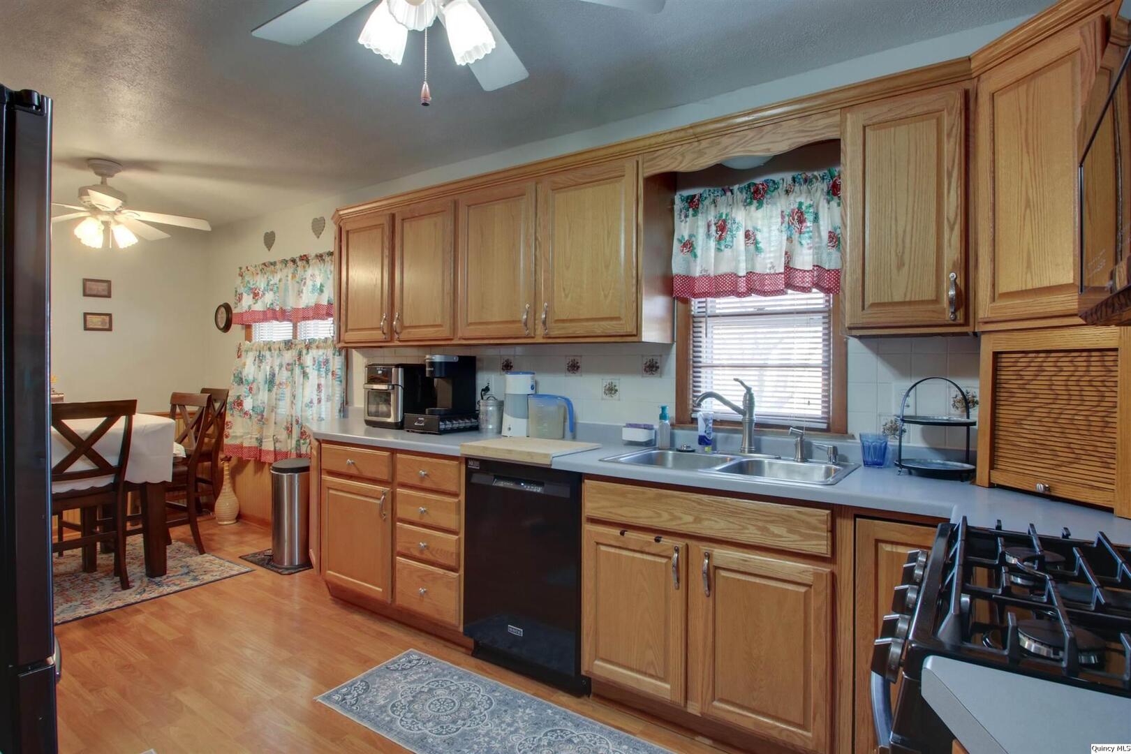 3608 Columbus Road Quincy, IL 62305 - Photo 8 of 17 a kitchen with stainless steel appliances granite countertop a sink stove and cabinets