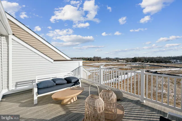 a view of a balcony with chair and wooden floor